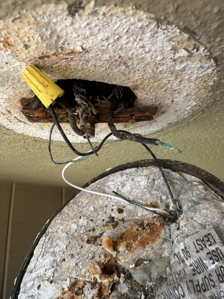 Old damaged electrical wiring with deteriorated connections exposed during repair in Daly City, CA