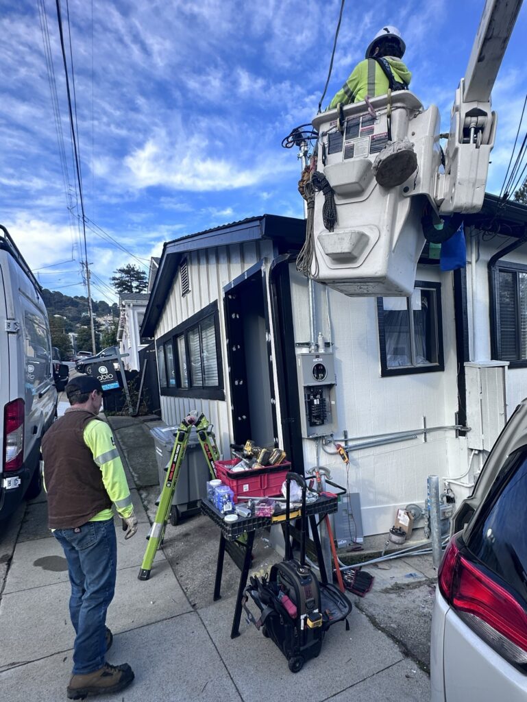 Electrical service upgrade with utility crew working from a bucket truck at a Bay Area residential property